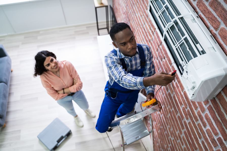 A man and woman repair an air conditioner in Glendora, CA