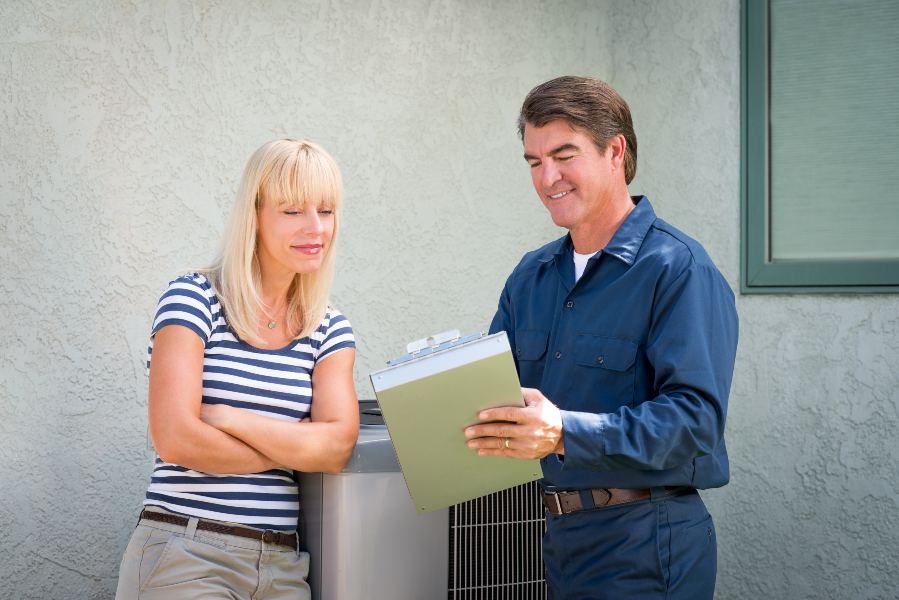 A man and woman stand beside an air conditioner in Glendora, CA