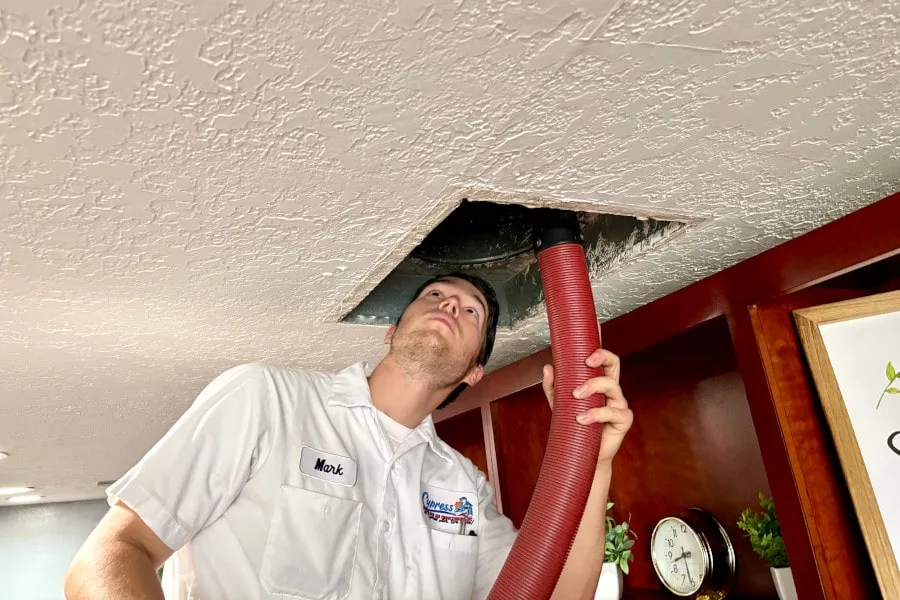 cypress air technician cleaning ductwork
